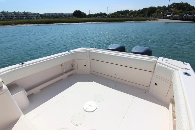 Slide: The Image of 2001 Grady-White Express 265 boat deck with dual engines on calm water. - 11