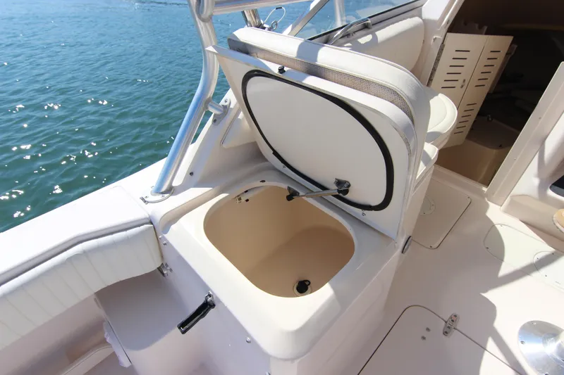 Slide: The Image of 2001 Grady-White Express 265 boat interior with open storage compartment by the water. - 15