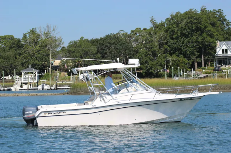 Slide: The Image of 2001 Grady-White Express 265 boat cruising on a serene waterway. - 2