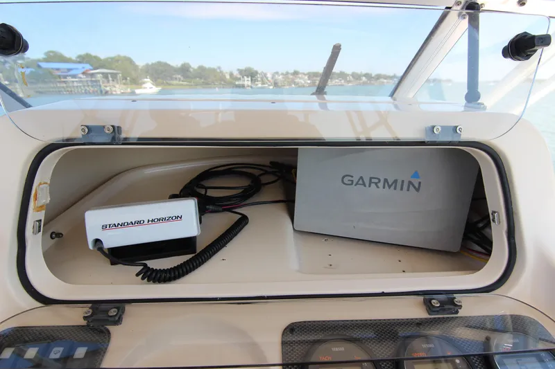 Slide: The Image of 2001 Grady-White Express 265 boat dashboard with Garmin and Standard Horizon equipment. - 23