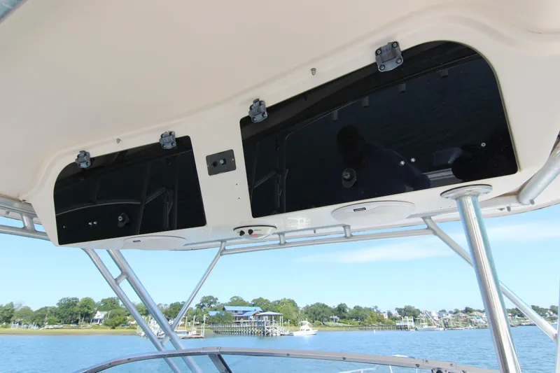 Slide: The Image of 2001 Grady-White Express 265 boat interior with overhead storage and scenic water view. - 24