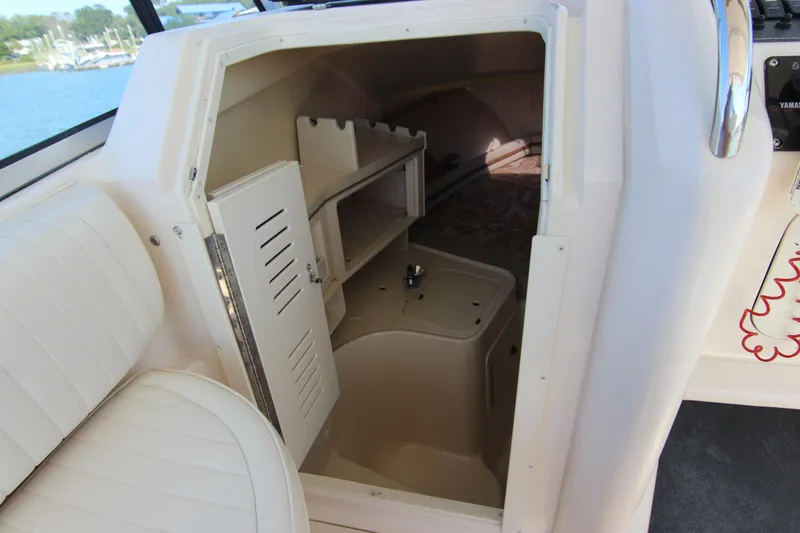 Slide: The Image of 2001 Grady-White Express 265 cabin interior with seating and storage compartments. - 25