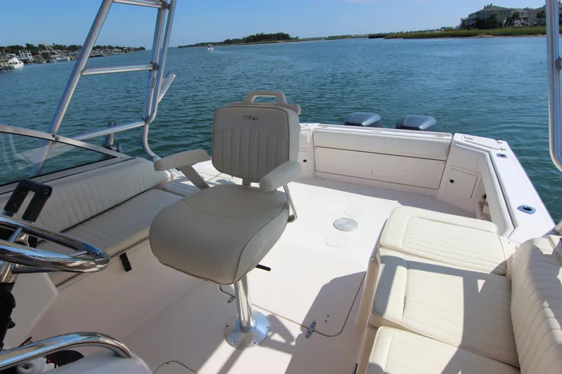 Slide: The Image of 2001 Grady-White Express 265 boat interior with seating, steering, and water view. - 30