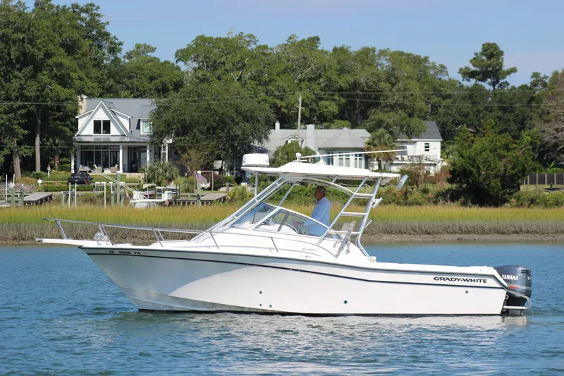 Slide: The Image of 2001 Grady-White Express 265 boat on calm water near waterfront homes. - 7