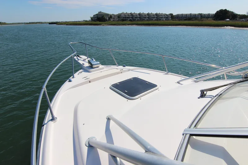 Slide: The Image of 2001 Grady-White Express 265 boat on calm water near shoreline. - 8