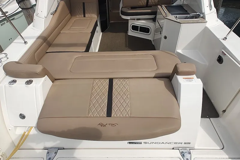 Slide: The Image of 2017 Sea Ray Sundancer 310 interior with beige seating and kitchenette. - 13