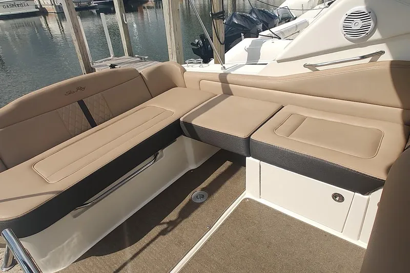 Slide: The Image of 2017 Sea Ray Sundancer 310 interior with beige seating and marine speaker. - 16