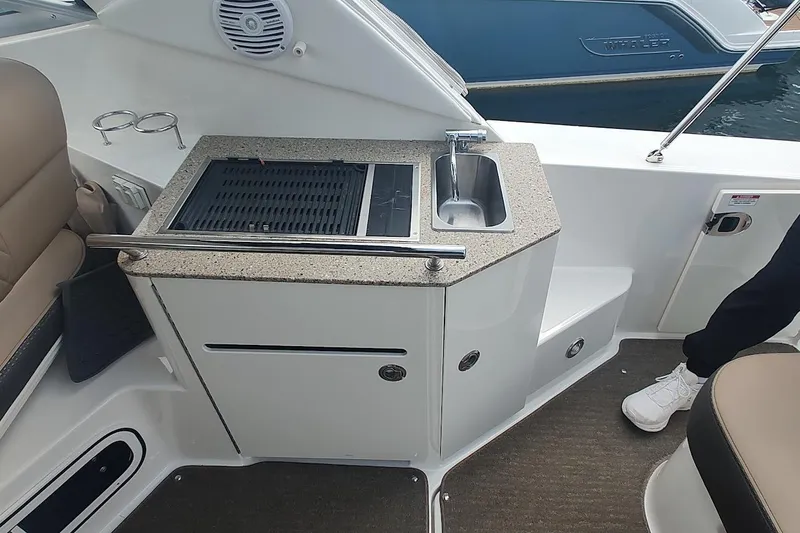 Slide: The Image of 2017 Sea Ray Sundancer 310 boat kitchenette with grill and sink. - 19