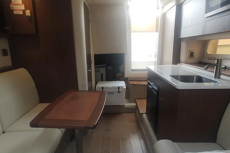 Slide: The Image of Interior of 2017 Sea Ray Sundancer 310 yacht with kitchenette and seating area. - 27