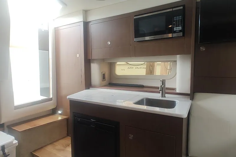 Slide: The Image of Interior of 2017 Sea Ray Sundancer 310 yacht with modern kitchenette and appliances. - 28