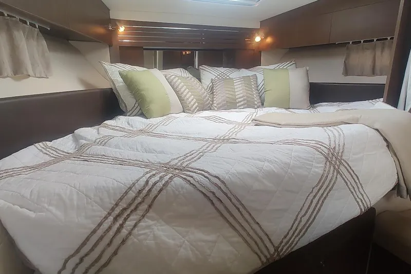Slide: The Image of Cozy cabin interior of 2017 Sea Ray Sundancer 310 with plush bedding and pillows. - 29