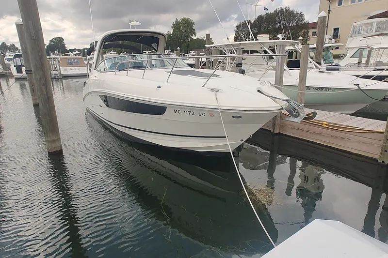Slide: The Image of 2017 Sea Ray Sundancer 310 docked at a marina under cloudy skies. - 3