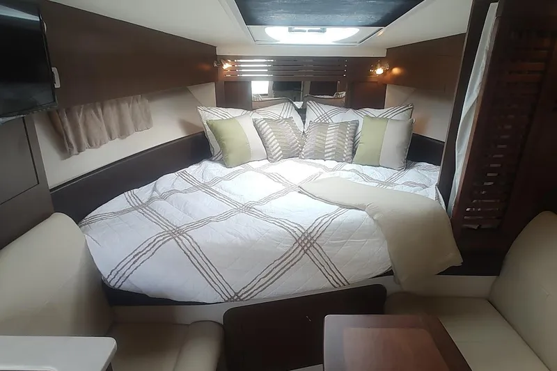 Slide: The Image of Luxurious cabin interior of 2017 Sea Ray Sundancer 310 with cozy bedding and modern decor. - 31