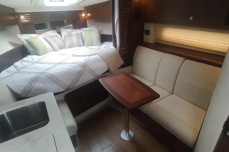 Slide: The Image of Luxurious interior of 2017 Sea Ray Sundancer 310 with cozy bed and seating area. - 32