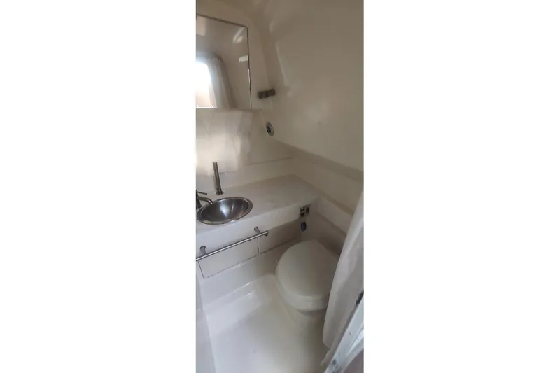 Slide: The Image of 2017 Sea Ray Sundancer 310 bathroom with sink and toilet, compact and modern design. - 35