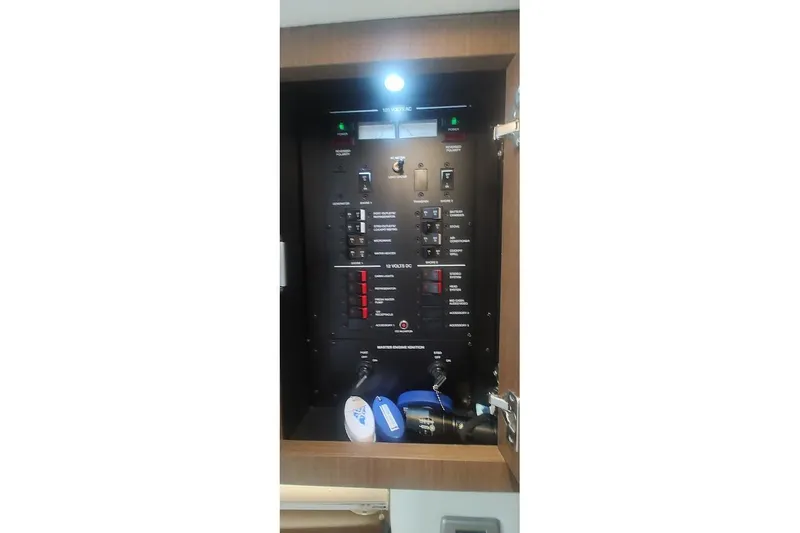 Slide: The Image of Electrical panel inside 2017 Sea Ray Sundancer 310 boat, featuring various switches and controls. - 36