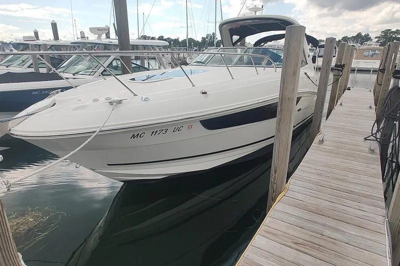 Slide: The Image of 2017 Sea Ray Sundancer 310 docked at marina, showcasing sleek design and modern features. - 6