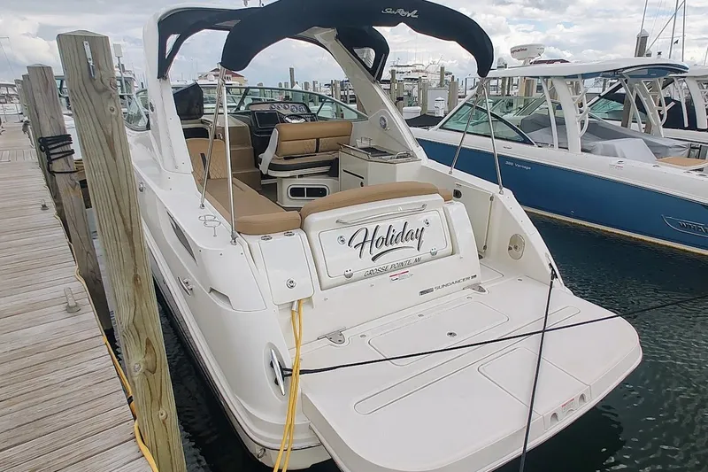 Slide: The Image of 2017 Sea Ray Sundancer 310 docked at marina, featuring spacious seating and sleek design. - 8