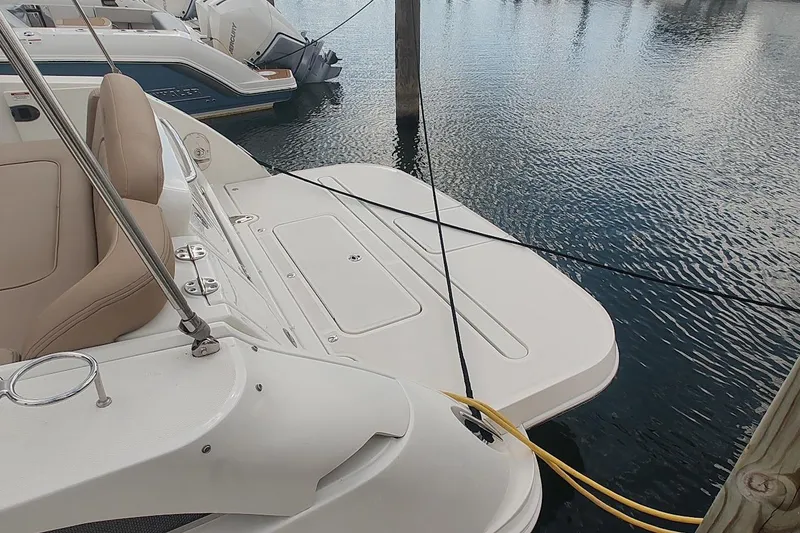Slide: The Image of 2017 Sea Ray Sundancer 310 docked, featuring a spacious swim platform and comfortable seating. - 9