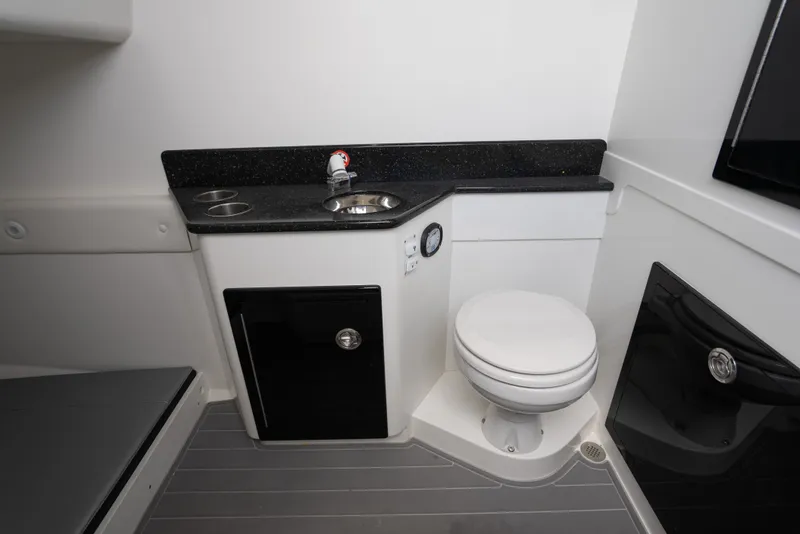 Slide: The Image of Interior of 2022 Concept 39' Open boat featuring a compact bathroom with sink and toilet. - 11