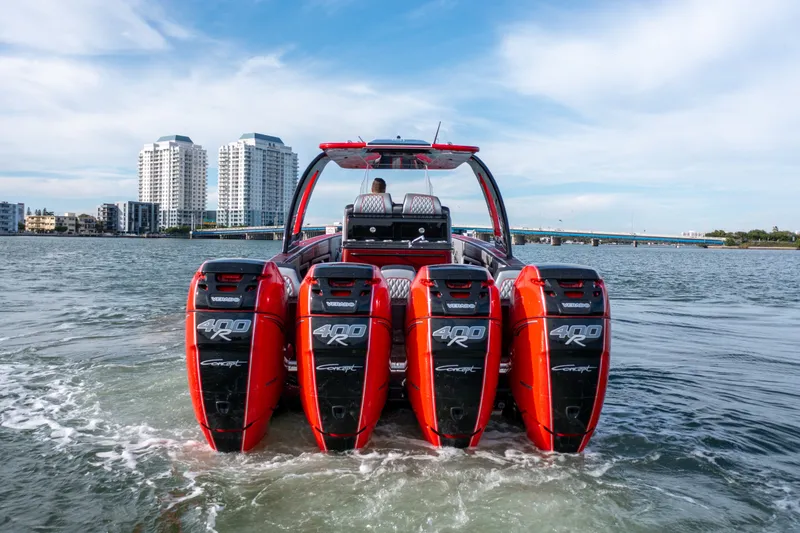 Slide: The Image of 2022 Concept 39' Open boat with four red outboard engines on water, cityscape background. - 2