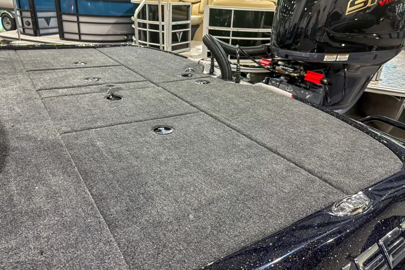 Slide: The Image of 2026 Skeeter ZXR19 boat deck with carpeted surface and visible engine. - 7