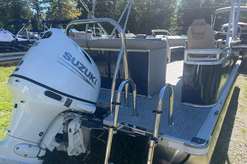 Slide: The Image of 2026 Avalon 21 LSZ Cruise pontoon boat with Suzuki outboard motor, docked outdoors. - 7