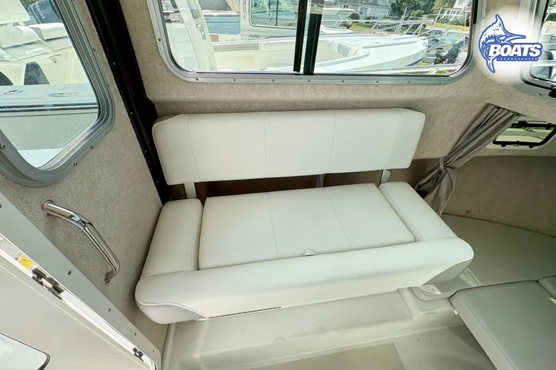 Slide: The Image of 2024 Parker 2320 SL Sport Cabin interior with white seating and windows. - 10