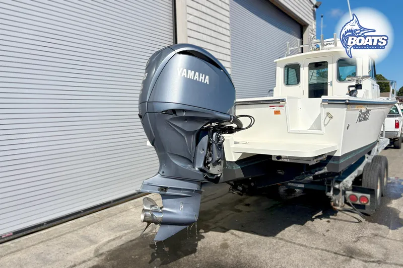 Slide: The Image of 2024 Parker 2320 SL Sport Cabin boat with Yamaha outboard motor on trailer. - 11