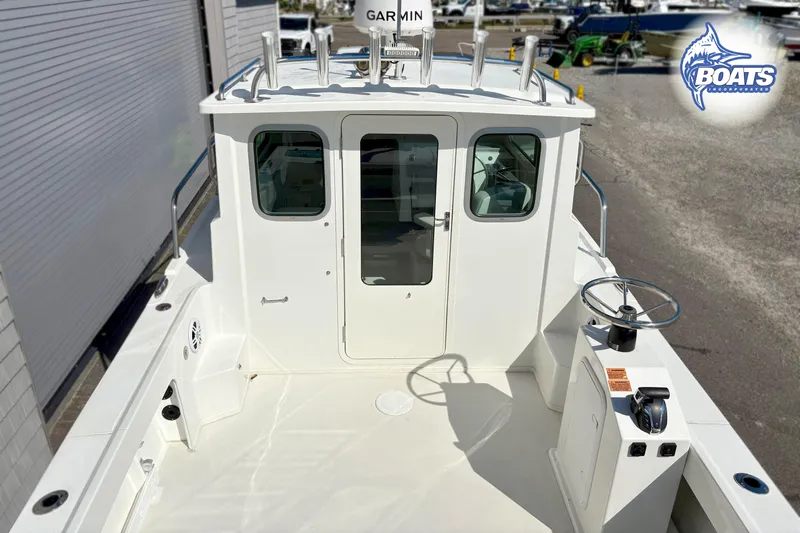 Slide: The Image of 2024 Parker 2320 SL Sport Cabin boat with spacious deck and modern controls. - 4