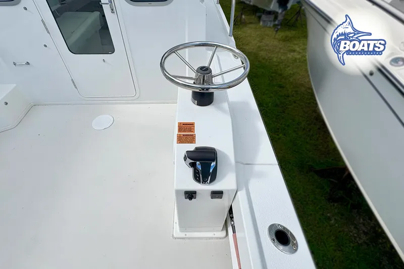 Slide: The Image of 2024 Parker 2320 SL Sport Cabin boat helm with steering wheel and controls. - 5