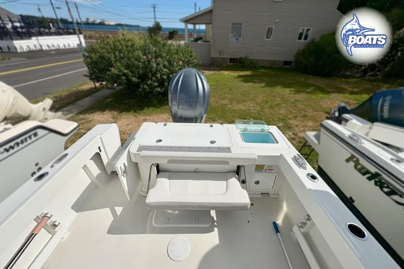 Slide: The Image of 2024 Parker 2320 SL Sport Cabin boat with spacious deck and seating area. - 6