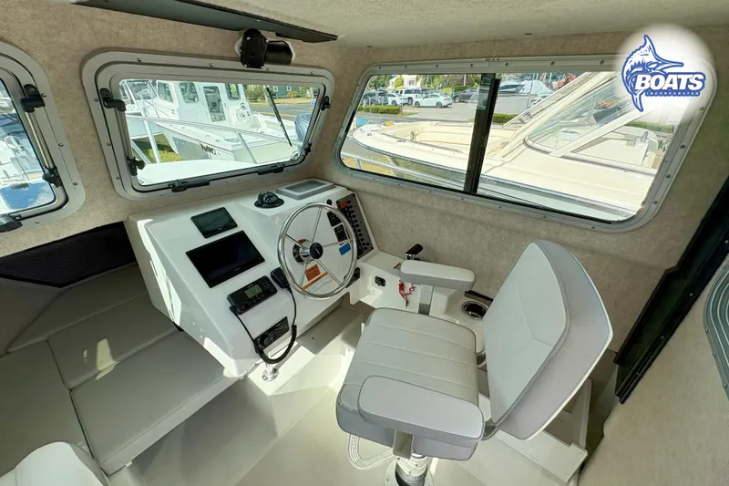 Slide: The Image of 2024 Parker 2320 SL Sport Cabin interior with steering wheel and seating. - 7
