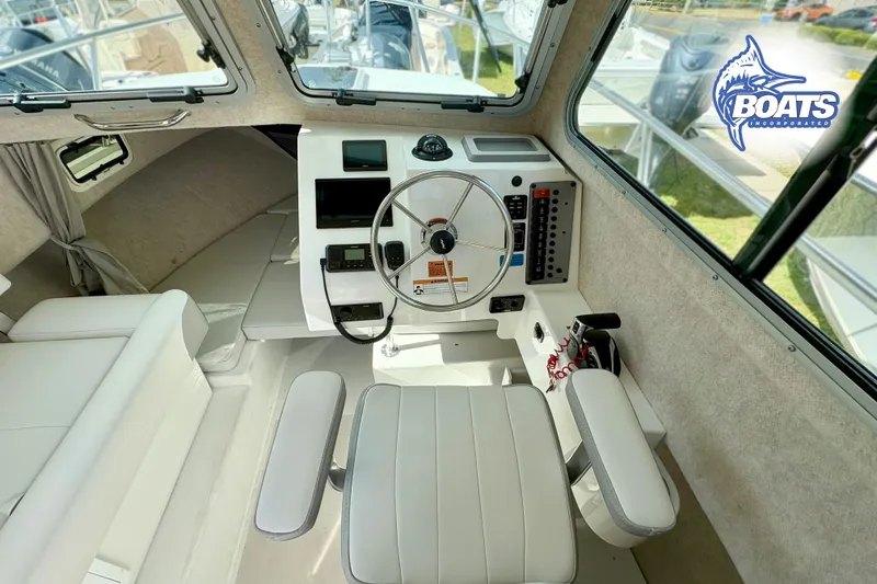 Slide: The Image of 2024 Parker 2320 SL Sport Cabin interior with steering wheel and control panel. - 8