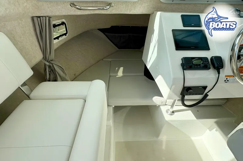 Slide: The Image of 2024 Parker 2320 SL Sport Cabin interior with seating and navigation equipment. - 9