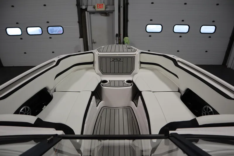 Slide: The Image of 2025 Yamaha Boats 252S interior with sleek seating and modern design in a garage setting. - 10