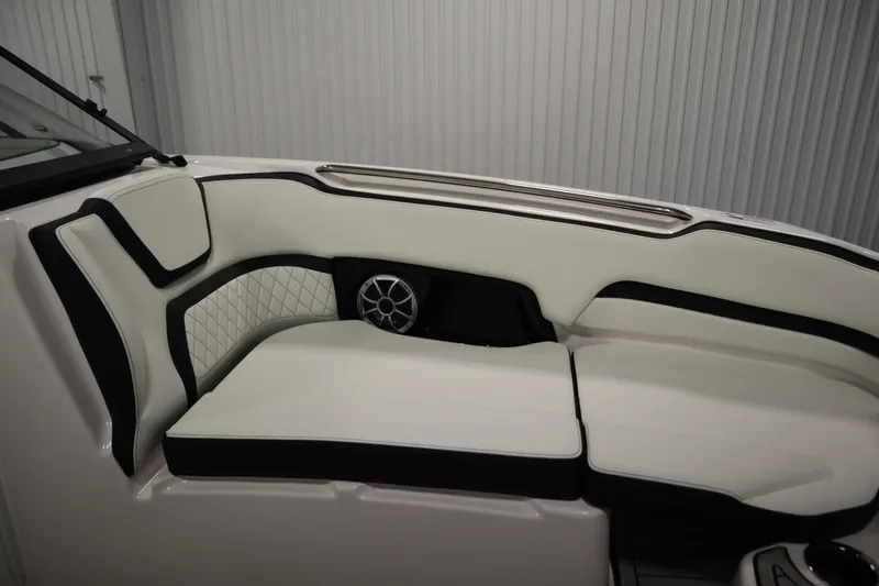 Slide: The Image of 2025 Yamaha Boats 252S interior with white and black seating, featuring a built-in speaker. - 13