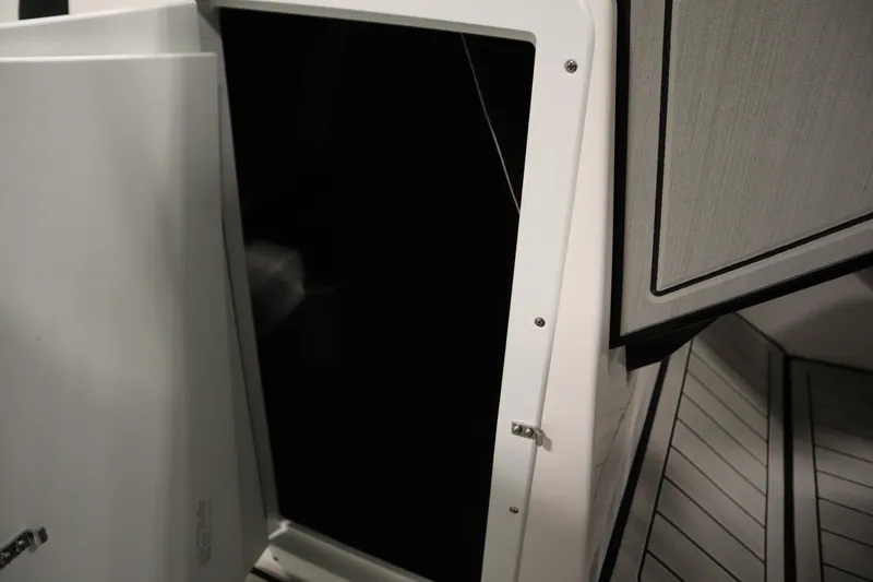 Slide: The Image of 2025 Yamaha Boats 252S interior storage compartment with sleek design and modern finish. - 16