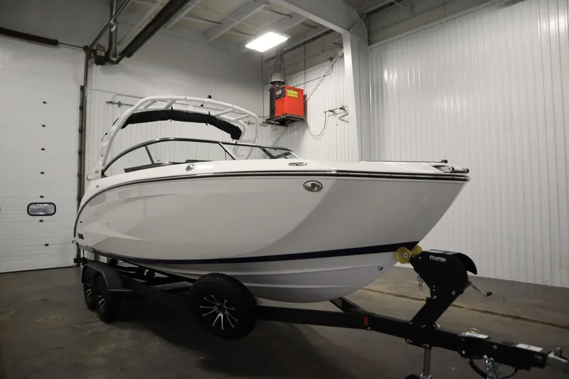 Slide: The Image of 2025 Yamaha Boats 252S in a garage, displayed on a trailer. - 2