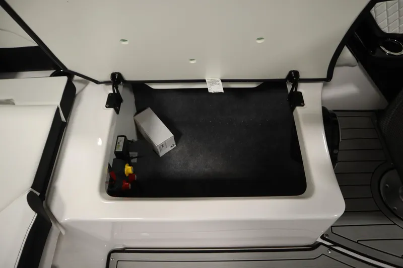 Slide: The Image of Storage compartment of 2025 Yamaha Boats 252S, featuring organized space and secure latches. - 32