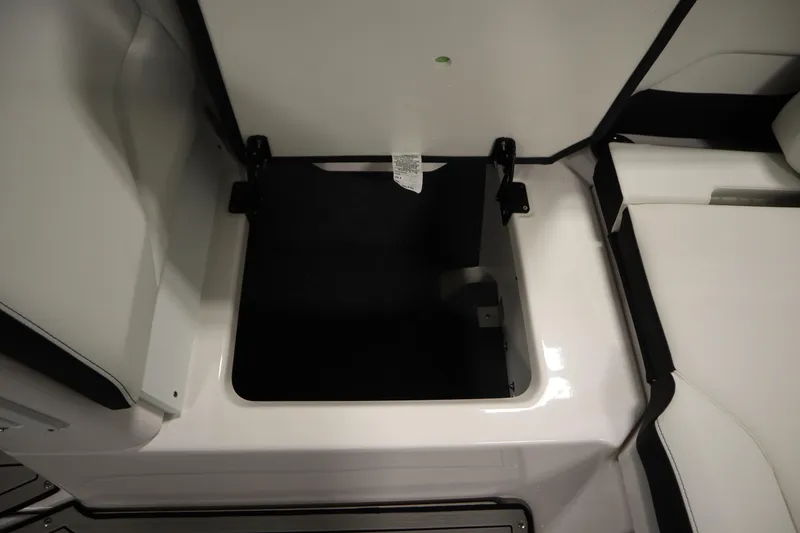 Slide: The Image of 2025 Yamaha Boats 252S storage compartment with open lid, showcasing interior space. - 35
