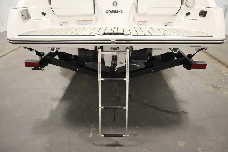 Slide: The Image of 2025 Yamaha Boats 252S rear view with swim platform and ladder. - 43