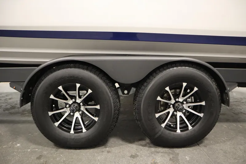 Slide: The Image of 2025 Yamaha Boats 252S trailer wheels, featuring sleek black rims and durable tires. - 47