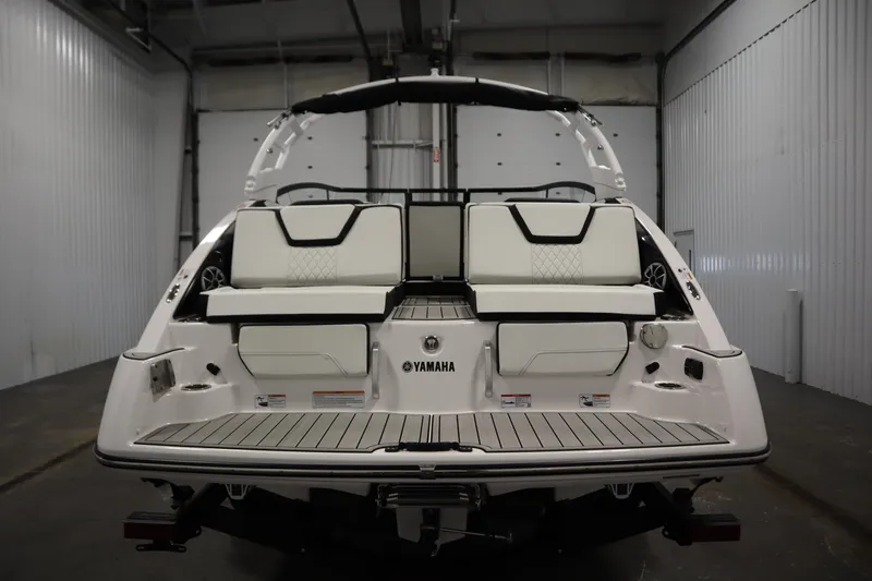 Slide: The Image of 2025 Yamaha Boats 252S, rear view in a garage, showcasing sleek design and seating. - 5