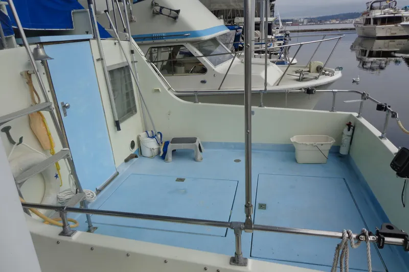 Slide: The Image of A 1976 Tolly sedan boat docked at a marina under a clear sky. - 1