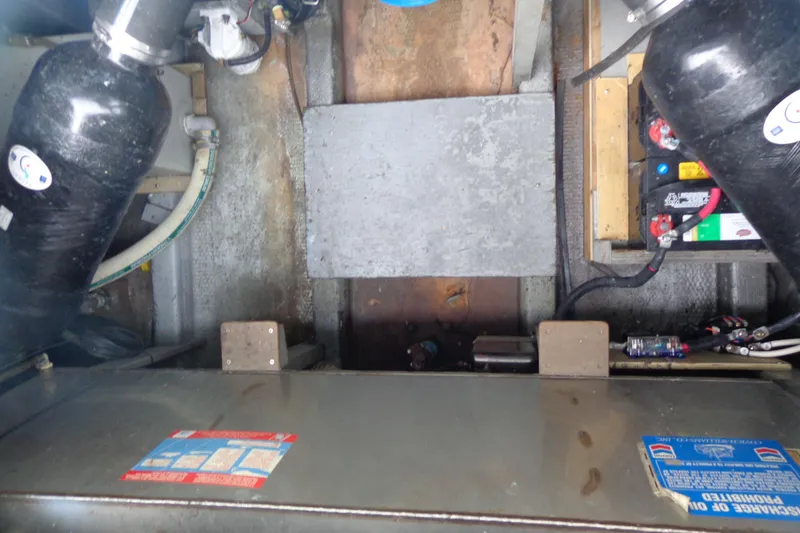 Slide: The Image of Engine compartment of a 1976 Tolly sedan with visible components and wiring. - 18