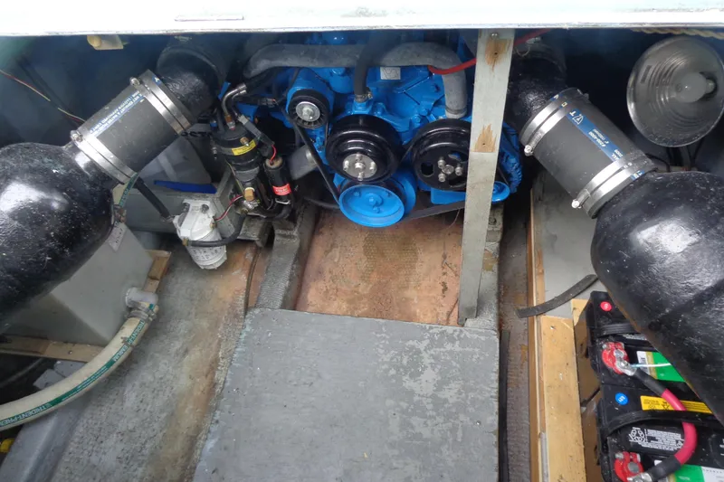 Slide: The Image of 1976 Tolly sedan engine compartment with blue engine and black hoses. - 19