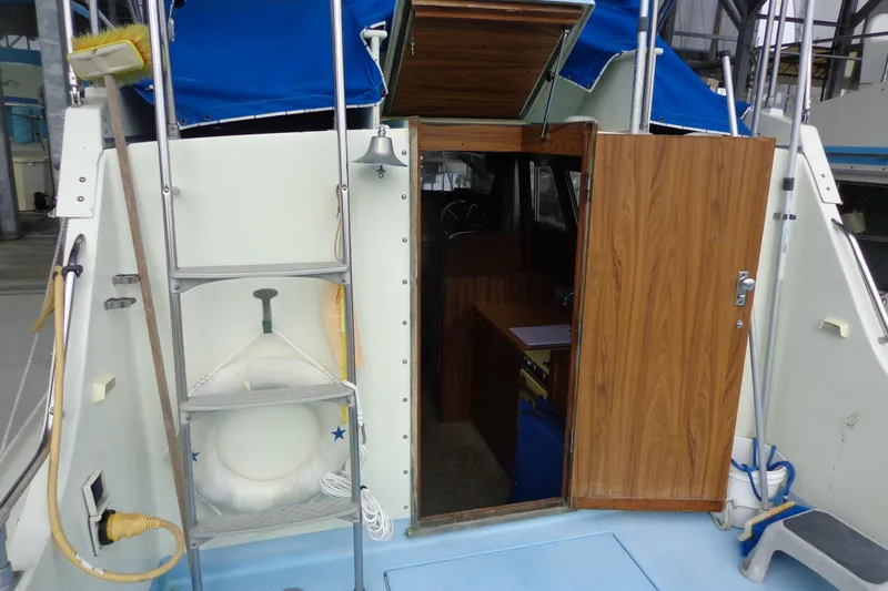 Slide: The Image of Boat interior with open wooden door, ladder, and life preserver. - 20