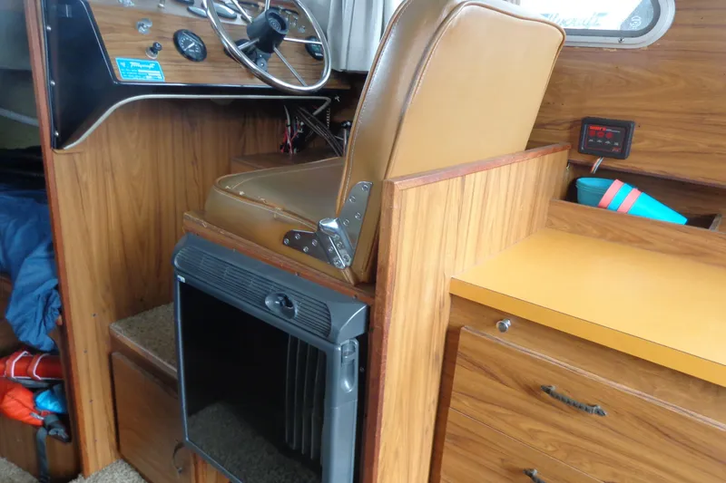 Slide: The Image of 1976 Tolly sedan interior with wood paneling, steering wheel, and brown leather seat. - 21