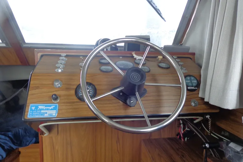 Slide: The Image of Steering wheel and dashboard of a vintage 1976 Tolly sedan boat. - 22